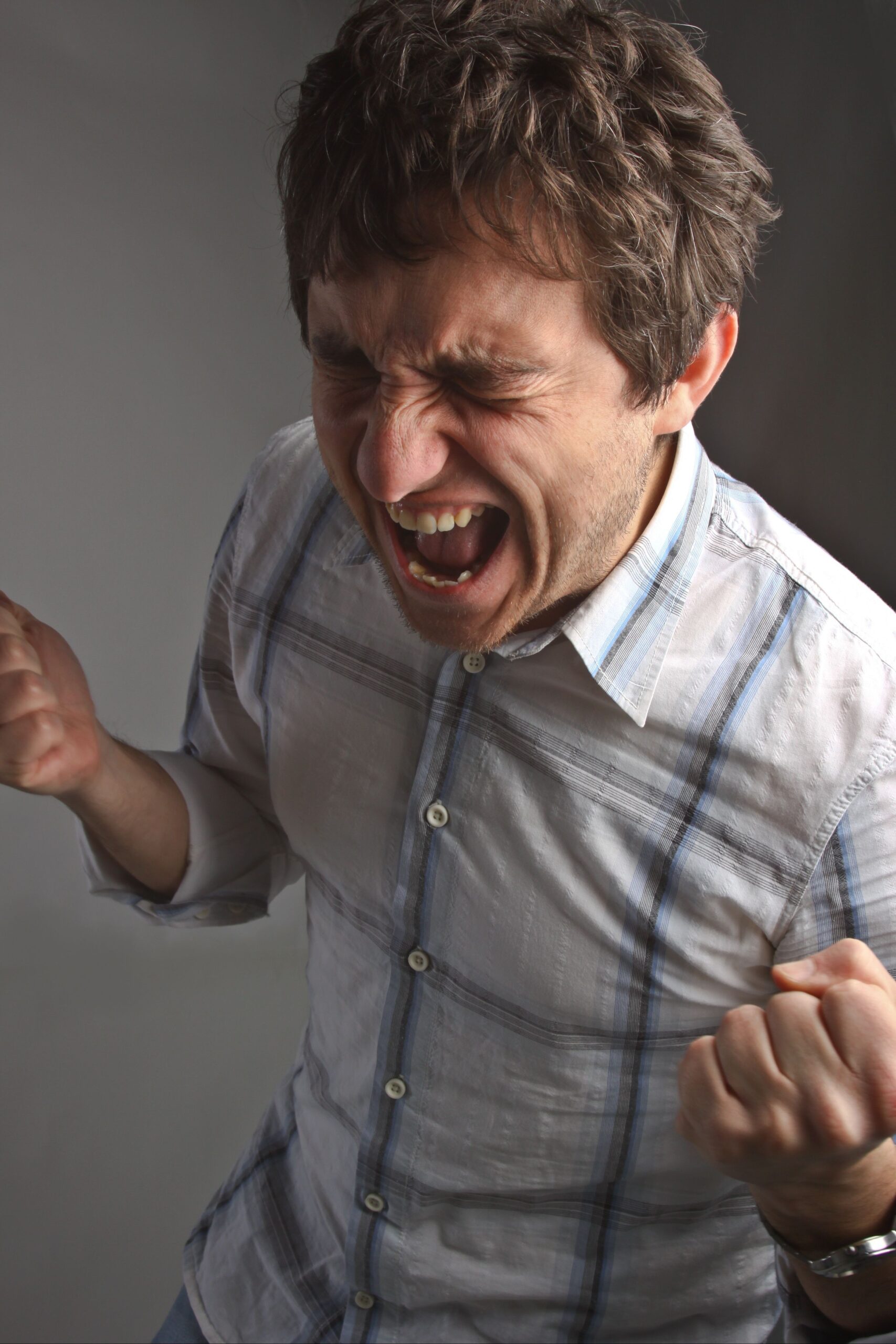 A man screaming in pain from his dental pain.