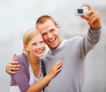 A young man and women smiling for a photo after Invisalign treatment in Billings.